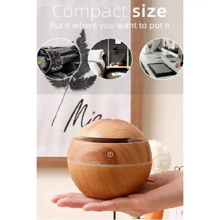 Compact light wood diffuser held in one hand