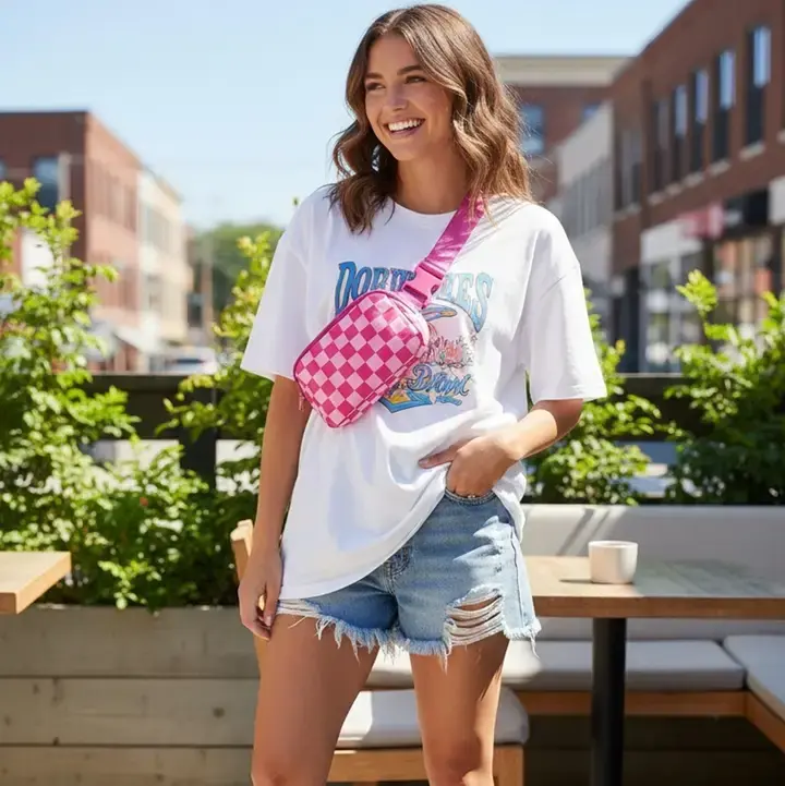Pink checker crossbody belt bag worn crossbody