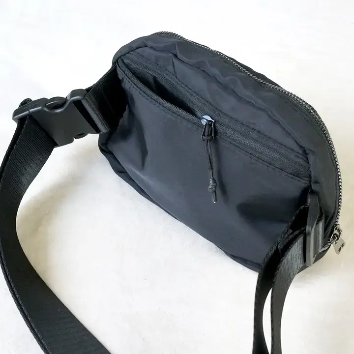 Black crossbody belt bag zipper and pocket detail